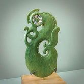Hand carved New Zealand Jade Manaia sculpture with wooden stand. This is a large New Zealand Flower Jade Manaia sculpture hand carved here in New Zealand. This is a one only work of art and will be shipped to you with express courier.